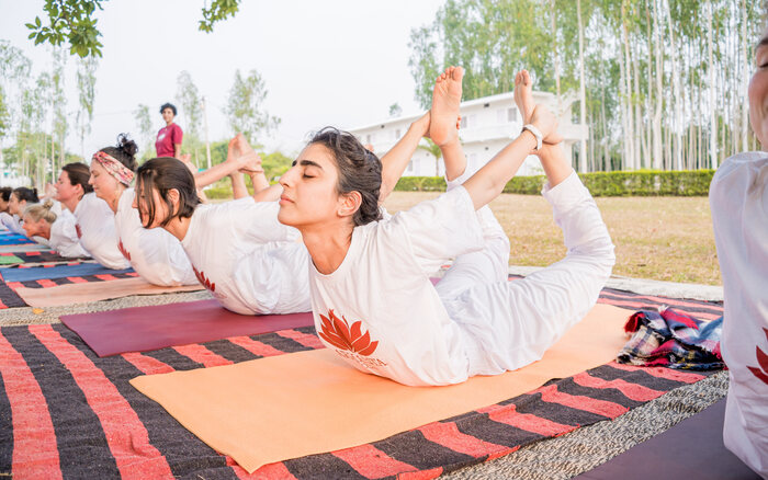 Arhanta yoga students bend in Bow Pose on a Yoga Teacher Training in India Arhanta yoga students bend in Bow Pose on a Yoga Teacher Training in India
