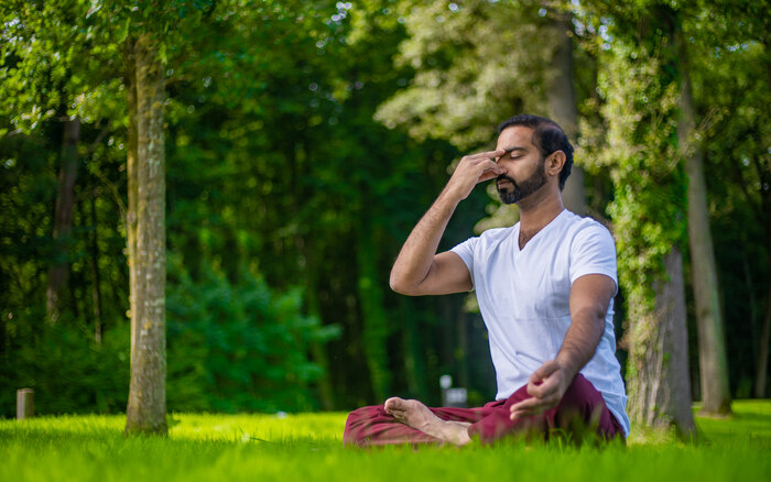 Male practitioner practices yoga for vertigo Male practitioner practices yoga for vertigo