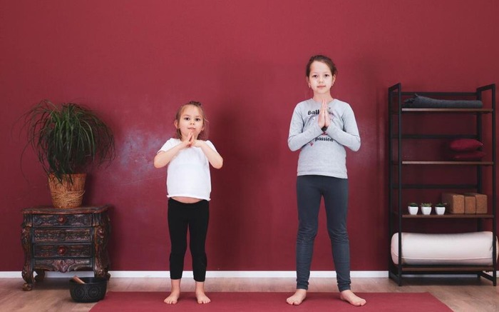 Two children practice mindful kids yoga poses Two children practice mindful kids yoga poses