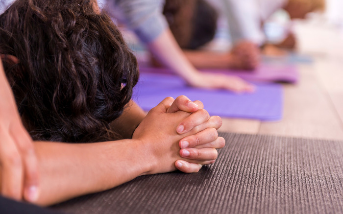 A woman practices yoga poses while traveling