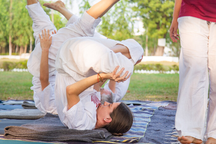Students complete practical asana training in a 200-hour yoga teacher course