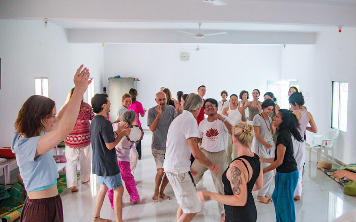 A yoga sangha dance and chant together A yoga sangha dance and chant together