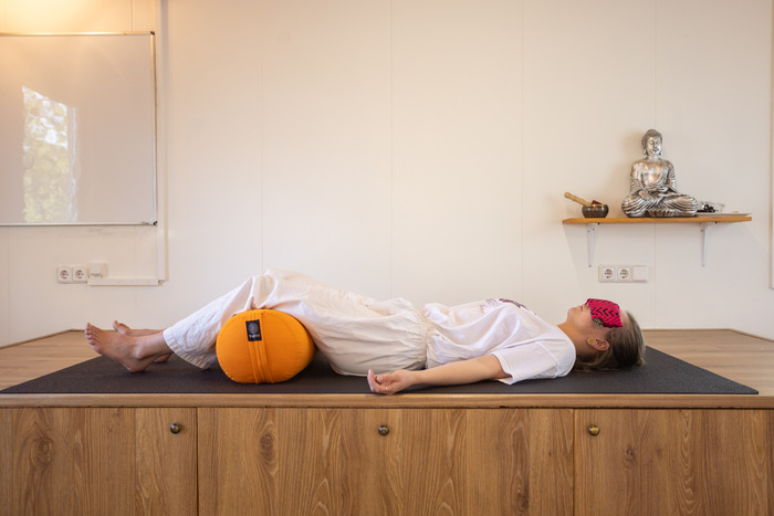 Yoga practitioner relaxes in a Yoga Nidra pose Yoga practitioner relaxes in a Yoga Nidra pose