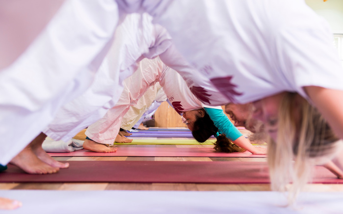 Yoga students practice yoga transitions Yoga students practice yoga transitions
