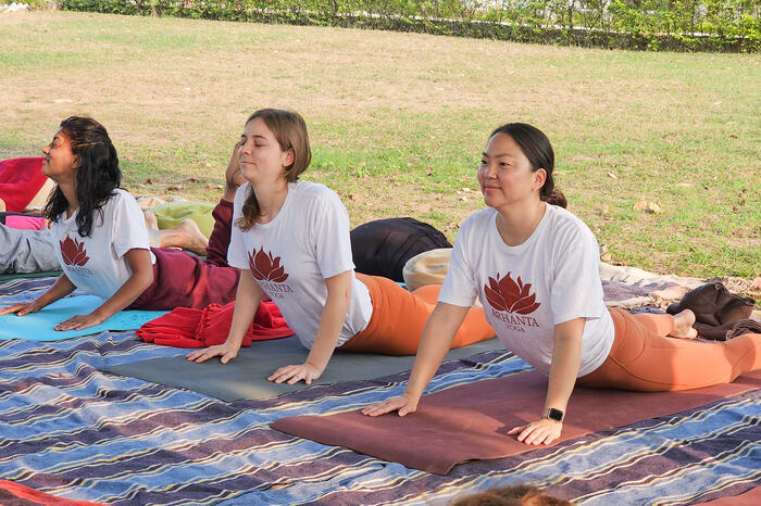 A group of yoga students practice restorative yoga poses for burnout relief A group of yoga students practice restorative yoga poses for burnout relief