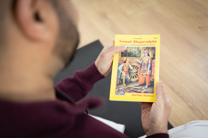 A yoga practitioner reads the Bhagavad Gita
