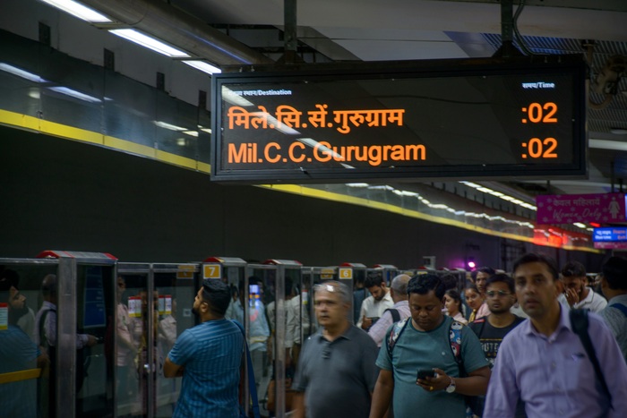 Commuters at a metro station in Delhi Commuters at a metro station in Delhi