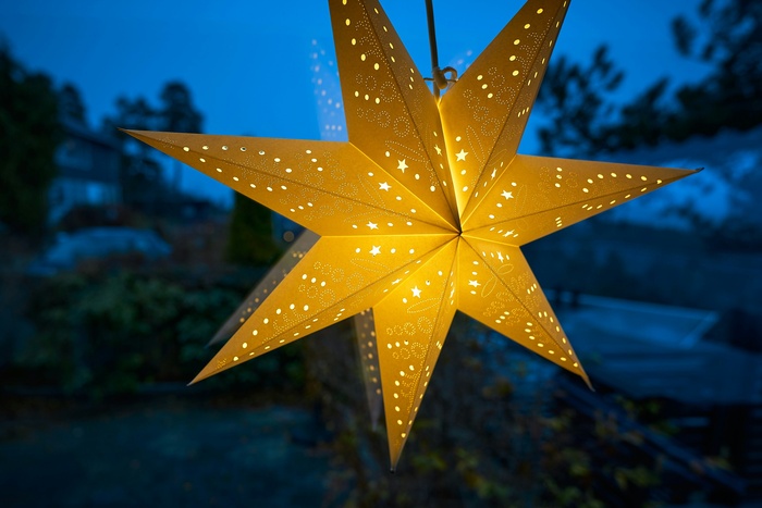 A paper Christmas star in a window A paper Christmas star in a window