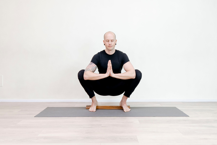 Male yoga practitioner in a yoga squat (Malasana)