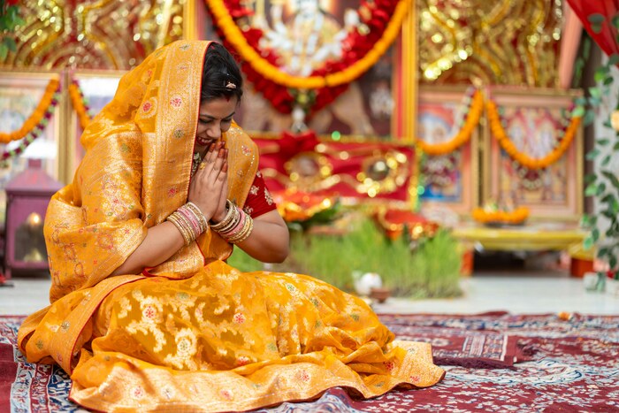 Traditional Indian Ceremony with Woman in Sari and namaste position Traditional Indian Ceremony with Woman in Sari and namaste position