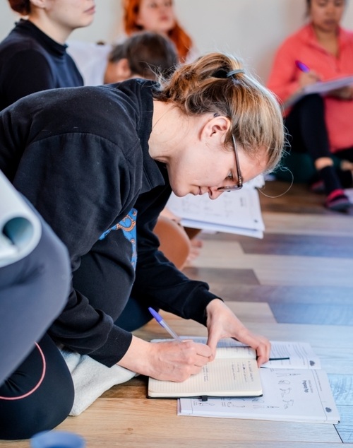 Yoga student setting her intention during her yoga teacher training
