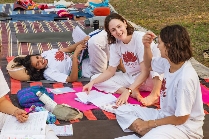 Small group of yoga students learn about relationships in yoga