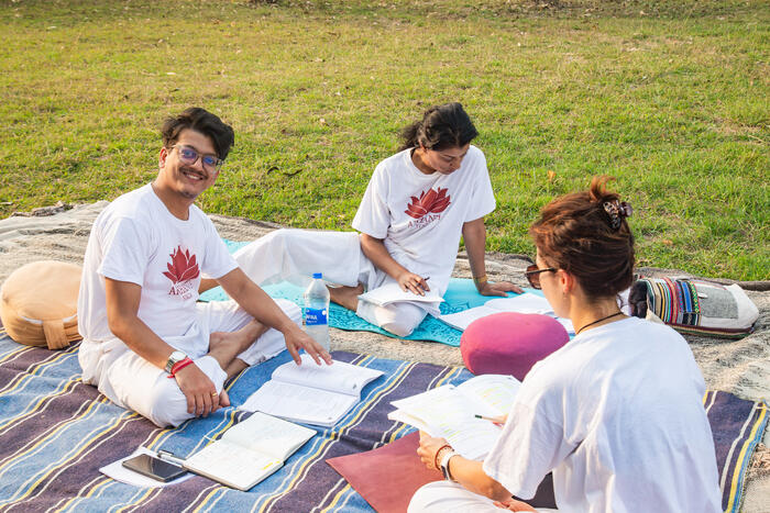 Yoga students study together outside in India Yoga students study together outside in India