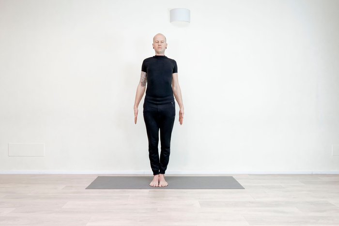 Practicing Mountain pose, best known as Tadasana Practicing Mountain pose, best known as Tadasana