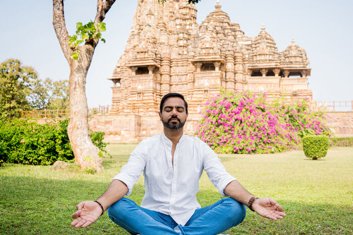 Seated in Padmasana also known as Lotus pose