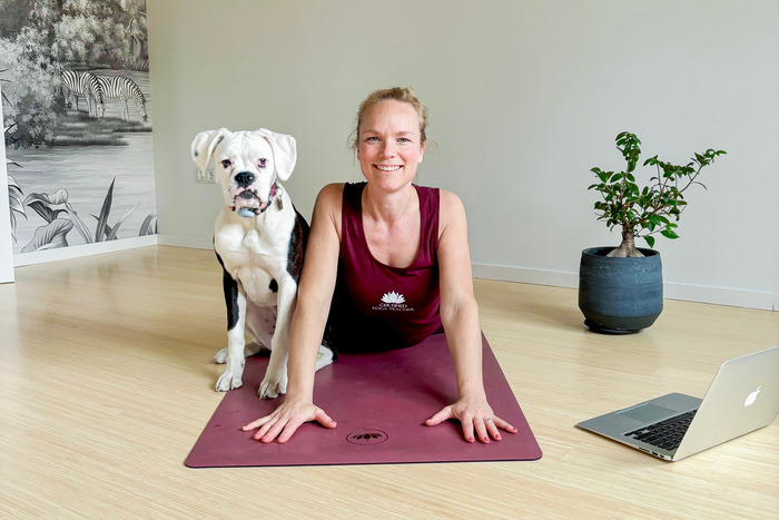 Student practicing her online yoga course practice