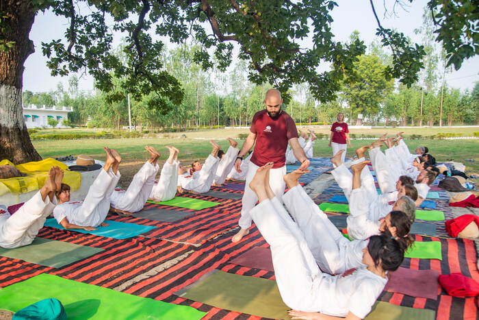 Yoga students in an outdoor yoga session at Arhanta yoga ashram