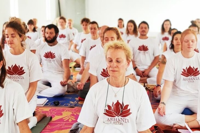 Class of yoga students in a guided meditation session