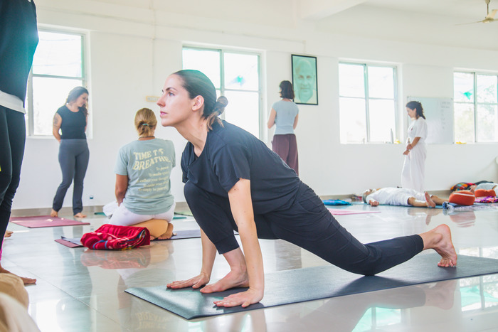 Yoga student learning beginner Hanumanasana at yoga ashram