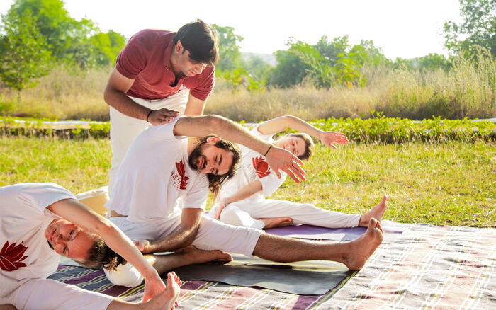 Master Yin Yoga Teacher helps a student hold a Yin Yoga Pose for a long duration - Characteristics of Yin Yoga Master Yin Yoga Teacher helps a student hold a Yin Yoga Pose for a long duration - Characteristics of Yin Yoga