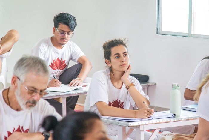 Students taking notes in a theory class in during their YTT 