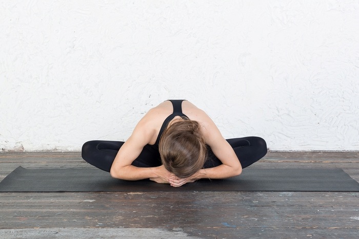 Women practitioners in Butterfly pose yin variation Woman practicing Butterfly Pose in Yin variation